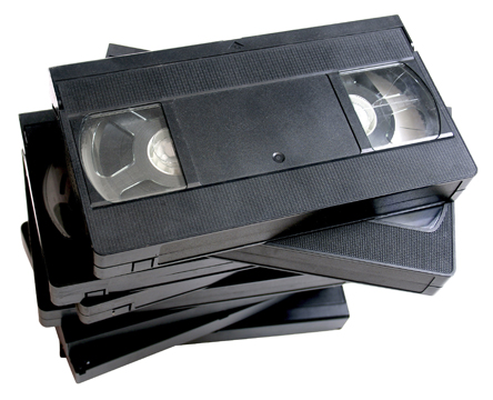 A stack collection of VHS tapes.
